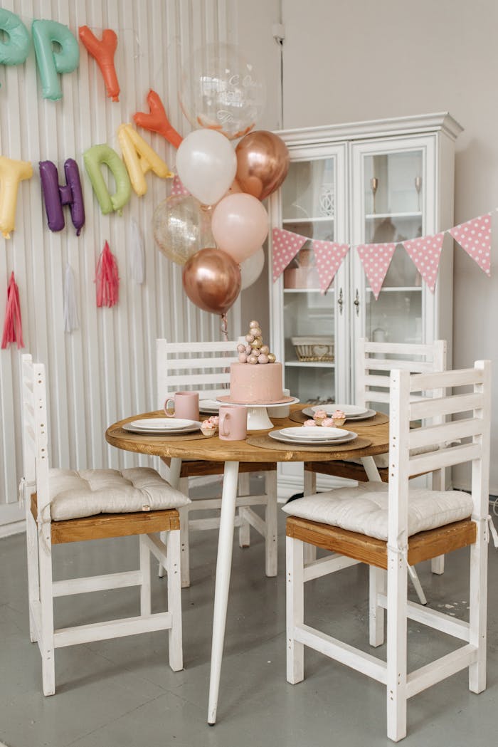 The Art of Drawing Readers In: Your attractive post title goes here Charming indoor children's birthday party setup with balloons and cake on a wooden table.